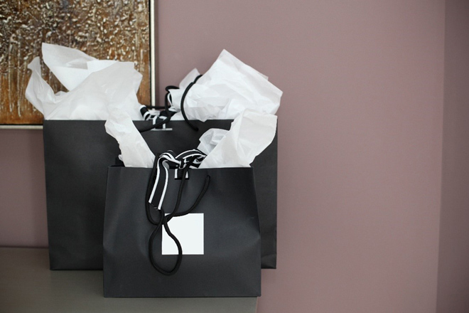 Black Gift Bags with Paper Filling on Table