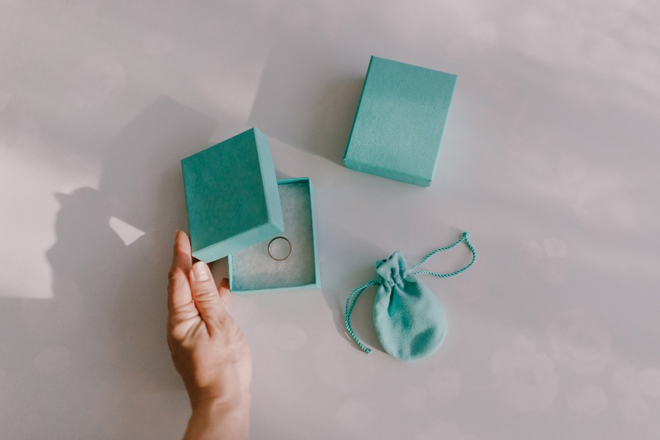 Turquoise Gift Box Opened by Hand