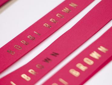 Bobbi Brown Red Ribbon with Gold Text